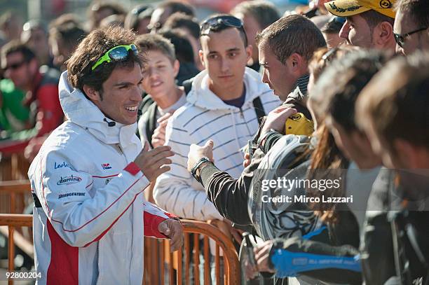 Toni Elias of Spain and San Carlo Honda Gresini speaks with fans during the event "Riders for Health" of last round of Comunitat Valenciana Grand...