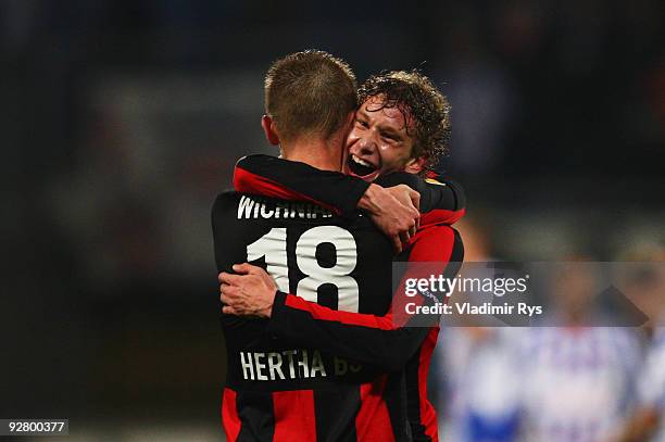 Fabian Lustenberger gives a hug to Artur Wichniarek of Hertha after the final whistle of the UEFA Europa League group D match between SC Heerenveen...