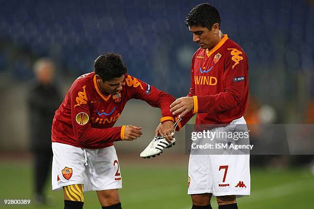 Cicinho and David Pizarro of AS Roma hold a the shoe during the UEFA Europa League group E match between AS Roma and Fulham at Olimpico Stadium on...