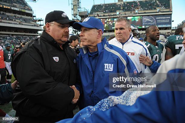 Head coach Andy Reid of the Philadelphia Eagles shakes hands with coach Tom Coughlin of the New York Giants after the game on November 1, 2009 at...