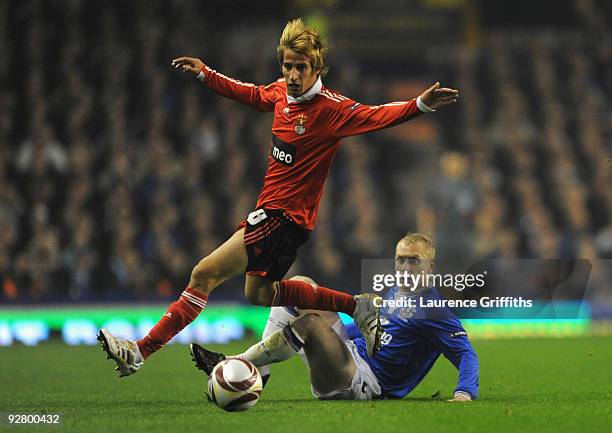 Tony Hibbert of Everton competes for the ball with Fabio Coentrao of Benfica during the UEFA Europa League Group I match between Everton and Benfica...