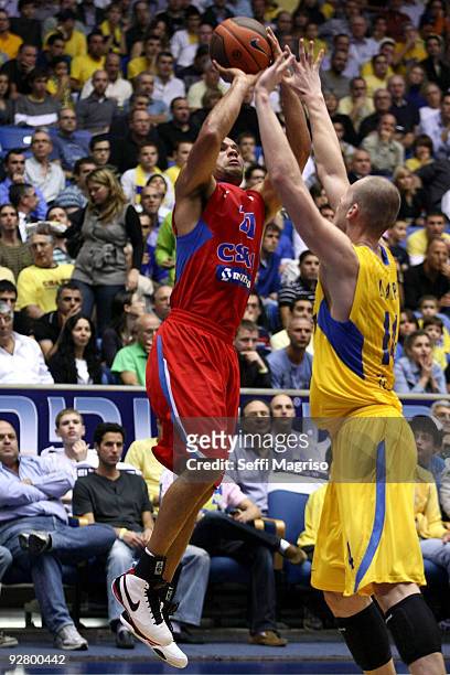 Trajan Langdon of CSKA Moscow competes with Maciej Lampe of Maccabi Electra in action during the Euroleague Basketball Regular Season 2009-2010 Game...