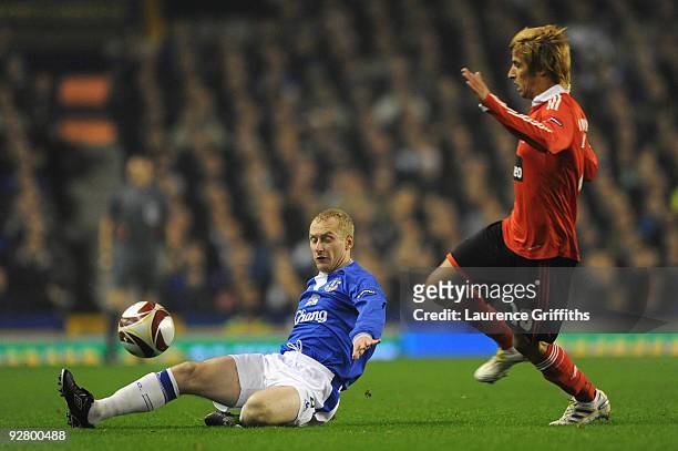 Tony Hibbert of Everton competes for the ball with Fabio Coentrao of Benfica during the UEFA Europa League Group I match between Everton and Benfica...
