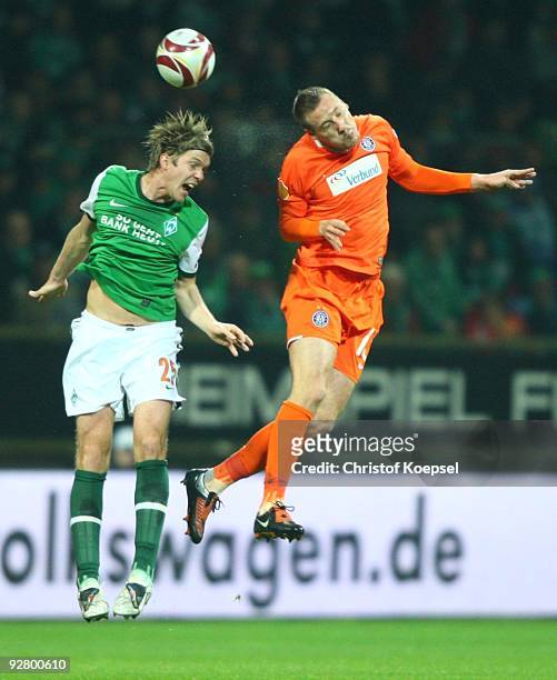 Peter Niemeyer of Bremen and Aleksandar Dragovic of Austria jump for header during the UEFA Europa League Group L match between Werder Bremen and...