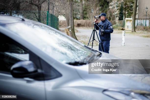 Police officer measures the speed of road users with a speedometer on February 27, 2018 in Berlin, Germany.