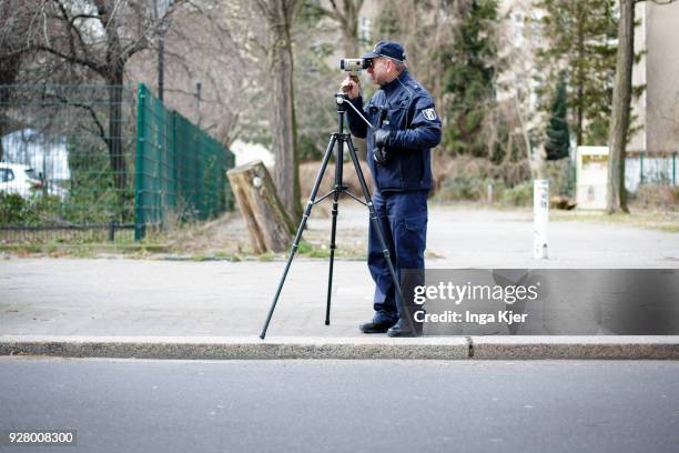 Police officer measures the speed of road users with a speedometer on February 27, 2018 in Berlin, Germany.