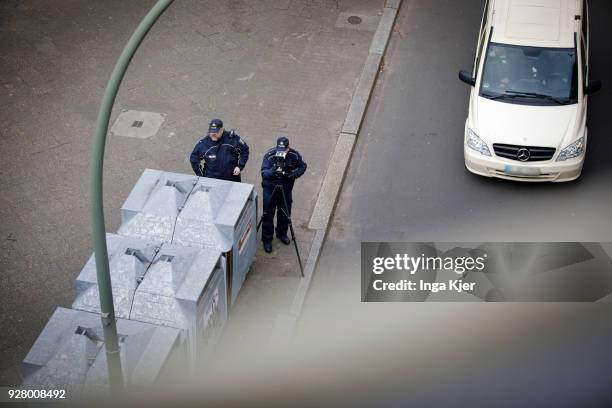 Two police officers measure the speed of road users with a speedometer on February 27, 2018 in Berlin, Germany.