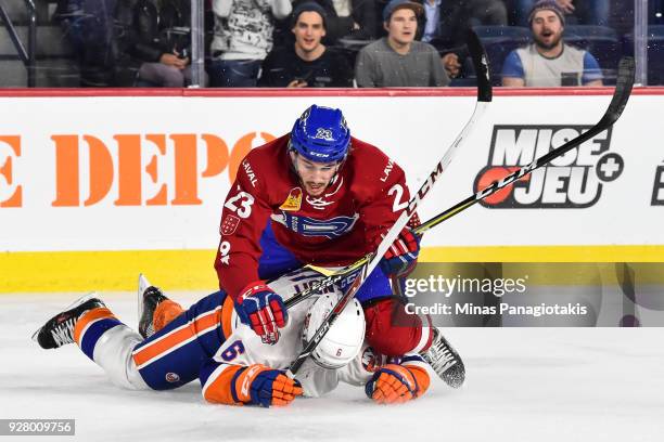 Niki Petti of the Laval Rocket takes down Andre Benoit of the Bridgeport Sound Tigers during the AHL game at Place Bell on March 2, 2018 in Laval,...