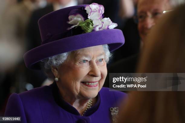 Queen Elizabeth II greets guests during a visit to the International Maritime Organization to mark the 70th anniversary of its formation on March 6,...
