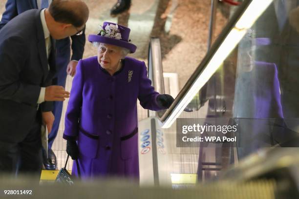 Queen Elizabeth II talks with Secretary-General of the International Maritime Organization Kitack Lim as she visits the International Maritime...