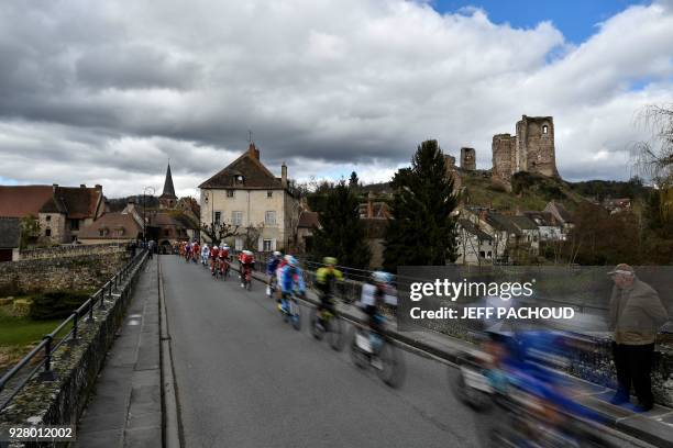 Spectator watches the pack riding past the 11th Century fortified castle Chateau d'Herisson during the third stage of the Paris - Nice cycling race...