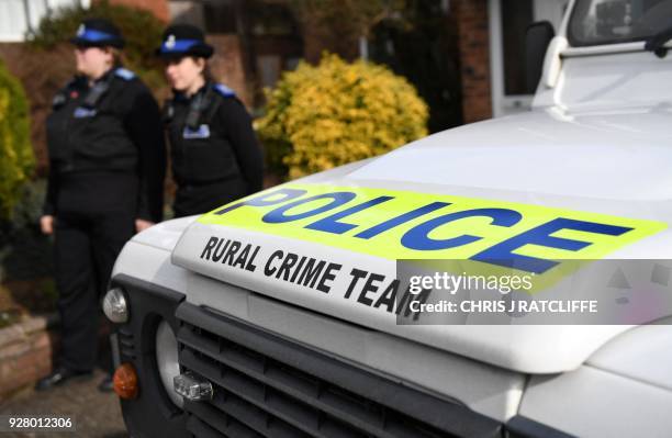 British Police Community Support Officers stand on duty outside a residential property in Salisbury, southern England, on March 6 believed to have...