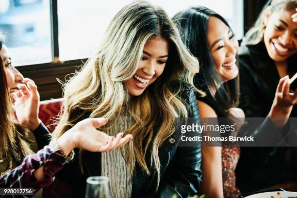 girl friends laughing together during lunch party - restaurant women friends lunch stock pictures, royalty-free photos & images