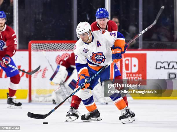Steve Bernier of the Bridgeport Sound Tigers skates the puck against Michael McCarron of the Laval Rocket during the AHL game at Place Bell on March...