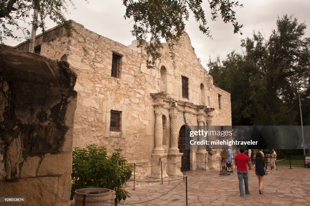 Tourist people walking visitors explore Alamo Spanish Mission San Antonio Texas