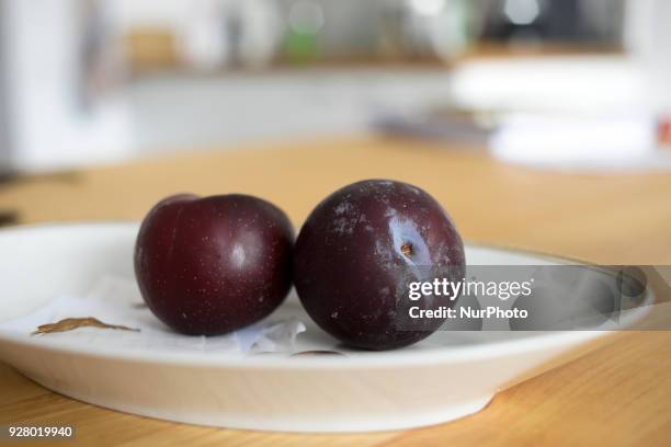 Plums are seen in a porcelain dish on March 6, 2018. English woman finds live rat inside bag of plums from Aldi.