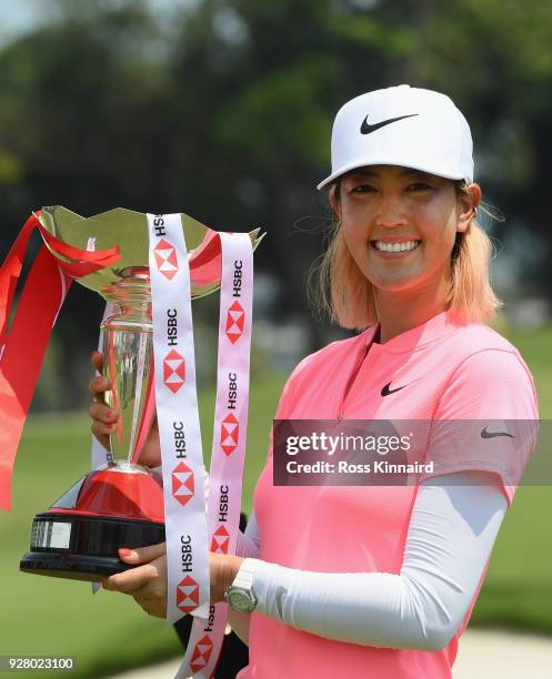 Michelle Wie of the United States celebrates with the winner's trophy after the final round of the HSBC Women's World Championship at Sentosa Golf...