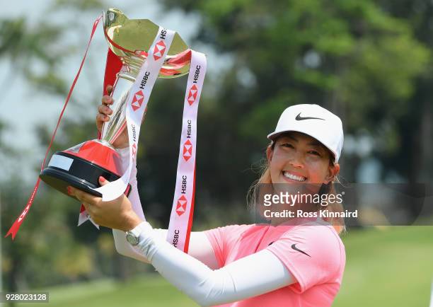 Michelle Wie of the United States celebrates with the winner's trophy after the final round of the HSBC Women's World Championship at Sentosa Golf...