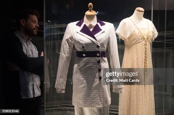 Man looks at two of Kate Winslet's dresses which she wore in her role as Rose in James Cameron's 1997 blockbuster film, and is being displayed as...