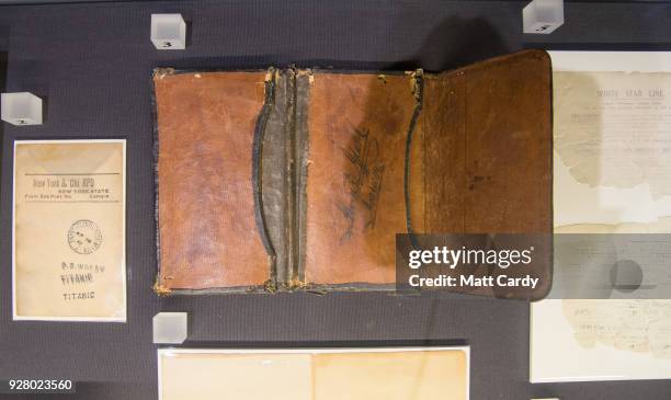 Wallet belonging to Mauritz Adahal, whose body was found in the water, and a facing slip belonging to postal clerk Oscar Woody and is being displayed...