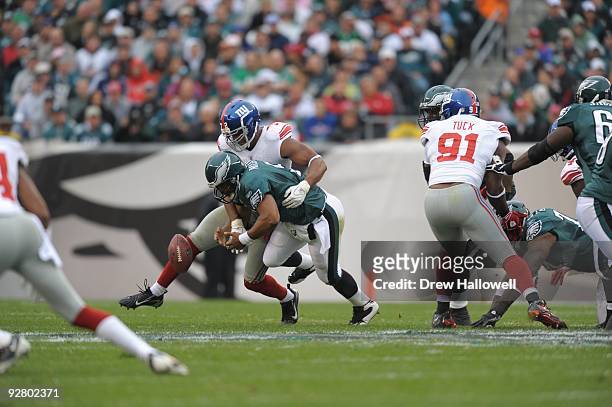 Quarterback Donovan McNabb of the Philadelphia Eagles fumbles while getting sacked by defensive end Osi Umenyiora of the New York Giants on November...