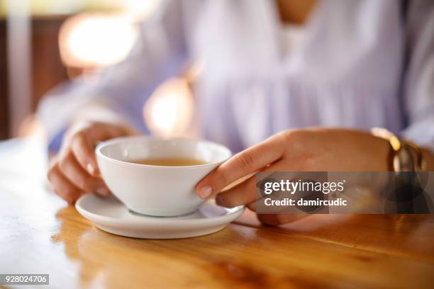 woman enjoying tea - drinking green tea stock pictures, royalty-free photos & images
