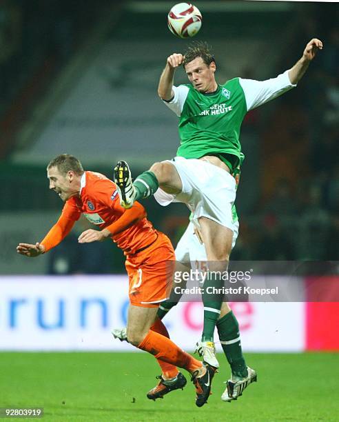 Milenko Acimovic of Austria and Tim Borowski of Bremen jump for a header during the UEFA Europa League Group L match between Werder Bremen and...