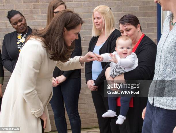 Catherine, The Duchess of Cambridge talks to Diane Leach and her daughter Tilly as she arrives to learn about the work of the charity Family Links...