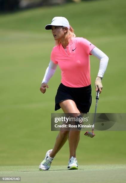 Picture 4 of 9 in a sequence showing the winning putt and celebration of Michelle Wie of the United States on the 18th green during the final round...