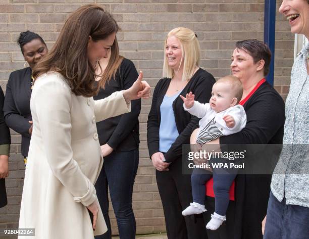 Catherine, Duchess of Cambridge talks to Diane Leach and her daughter Tilly as she arrives to learn about the work of the charity Family Links which...