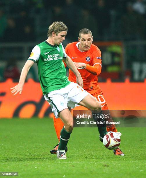 Peter Niemeyer of Bremen and Schumacher of Austria battle for the ball during the UEFA Europa League Group L match between Werder Bremen and Austria...