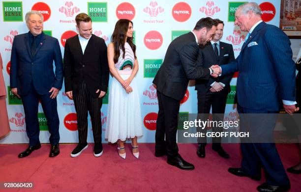 Britain's Prince Charles, Prince of Wales reacts as he meets Celebrity Trust Ambassadors Weslh singer Tom Jones, English singer Olly Murs, English...