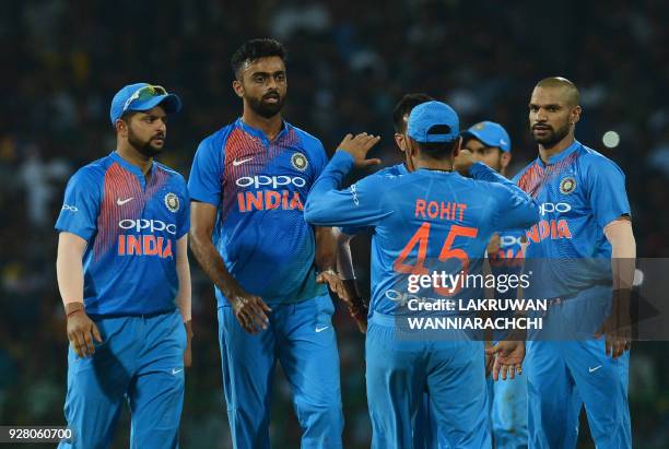 Indian cricketer Jaydev Unadkat celebrates with his teammates after he dismissed Sri Lankan cricketer Danushka Gunathilaka during the opening...