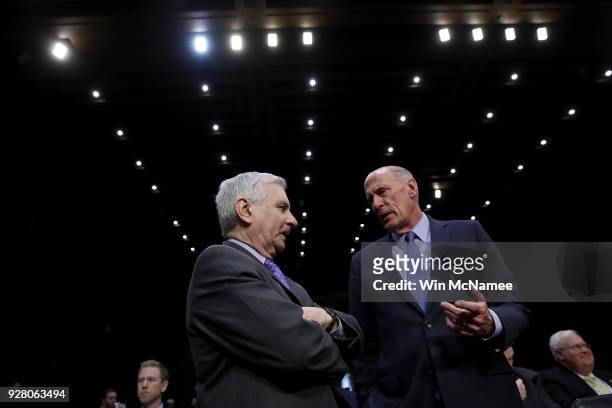 Director of National Intelligence Daniel Coats confers with ranking Senate Armed Services Committee member Sen. Jack Reed before the start of a...