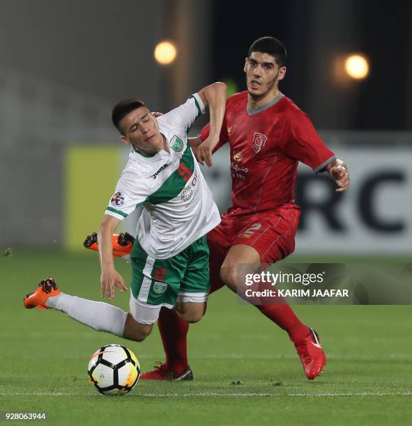 L-Duhail Karim Boudiaf views for the ball with Lokomotiv's Sardor Mirzayev during the AFC Champions League football match between Lokomotiv of...