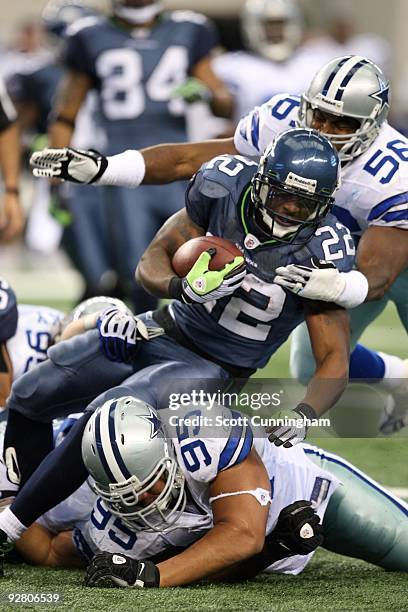 Julius Jones of the Seattle Seahawks is tackled by Bradie James of the Dallas Cowboys at Cowboys Stadium on November 1, 2009 in Arlington, Texas.