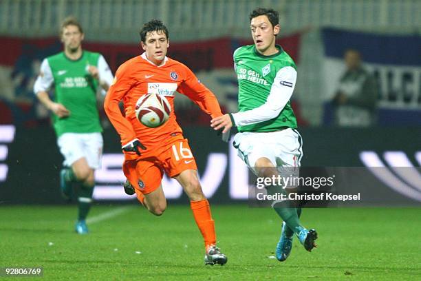 Zlatko Junuzovic of Austria and Mesut Oezil of Bremen battle for the ball during the UEFA Europa League Group L match between Werder Bremen and...