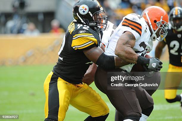 Linebacker James Harrison of the Pittsburgh Steelers tackles running back Jamal Lewis of the Cleveland Browns during a game at Heinz Field on October...