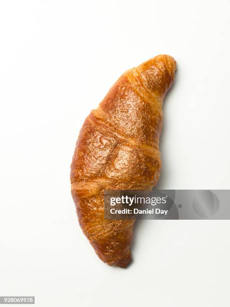 golden glitter croissant on white background - croissant stockfoto's en -beelden