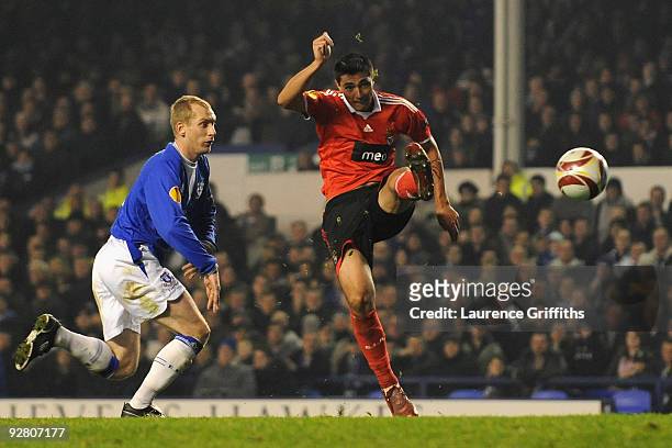Tony Hibbert of Everton is unable to prevent Oscar Cardozo of Benfica scoring his team's second goal during the UEFA Europa League Group I match...