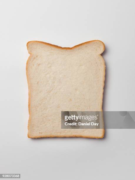 series of different sliced white bread slices, some with butter, crust and pile of slices against a white background shot from above - white bread fotografías e imágenes de stock