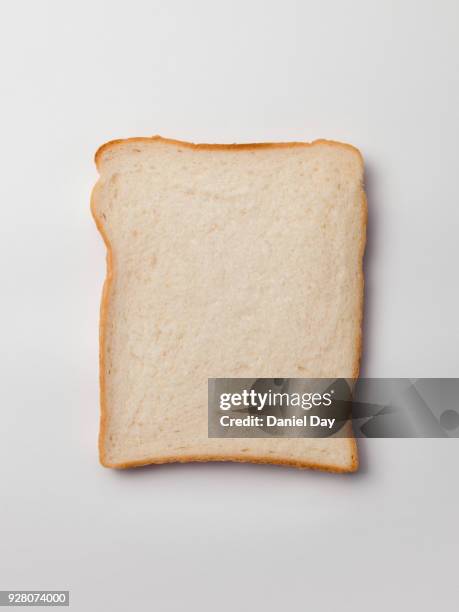 series of different sliced white bread slices, some with butter, crust and pile of slices against a white background shot from above - fatia - fotografias e filmes do acervo