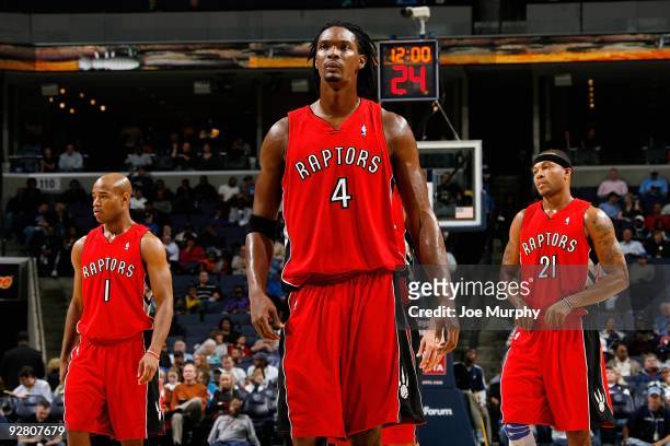 Jarrett Jack and Chris Bosh and Antoine Wright of the Toronto Raptors stand on the court during the game against the Memphis Grizzlies on October 30,...