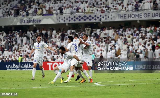 Esteghlal FC's players celebrate after scoring a goal against Al-Ain FC during their AFC Champions League group match at Hazza Bin Zayed Stadium, on...