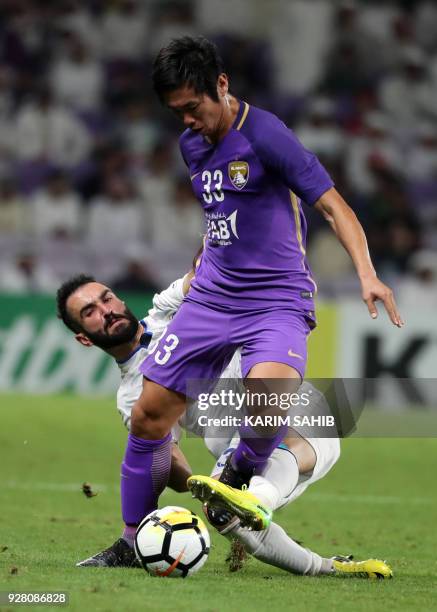 Al-Ain's Japanse midfielder Tsukasa Shiotani vies against Esteghlal FC's Iranian midfielder Dariush Shojaeian during their AFC Champions League group...