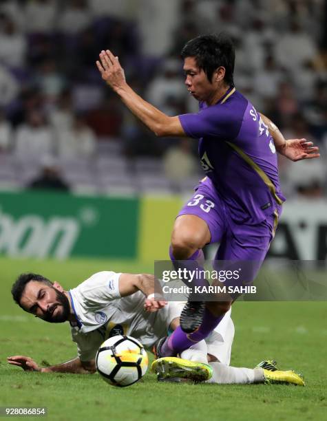 Al-Ain's Japanse midfielder Tsukasa Shiotani vies against Esteghlal FC's Iranian midfielder Dariush Shojaeian during their AFC Champions League group...