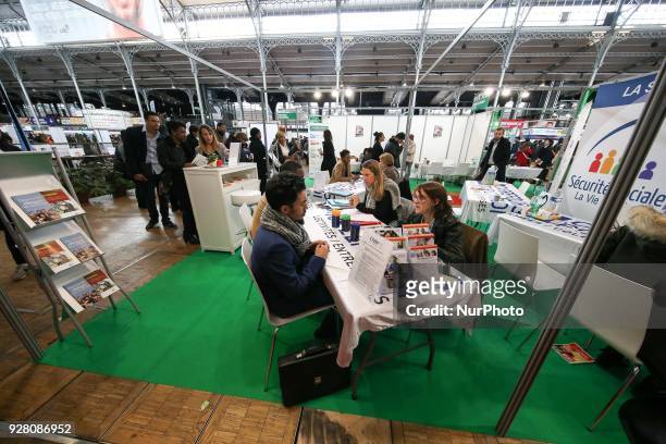 Jobseekers talk with members of French Social Security recruitment departement at the &quot;Paris pour l'emploi&quot; recruitment forum on March 6 at...