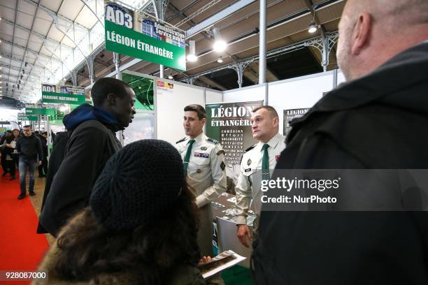 Jobseekers talk with members of French Foreign Legion recruiter staff at the &quot;Paris pour l'emploi&quot; recruitment forum on March 6 at the...