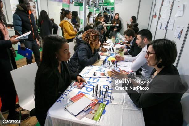 Jobseekers talk with members of recruitment services at the &quot;Paris pour l'emploi&quot; recruitment forum on March 6 at the Grande Halle de La...