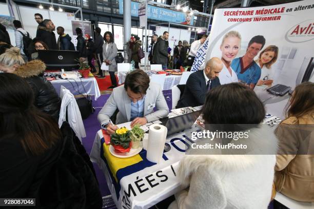 Jobseeker talks with a member of recruitment service at the &quot;Paris pour l'emploi&quot; recruitment forum on March 6 at the Grande Halle de La...